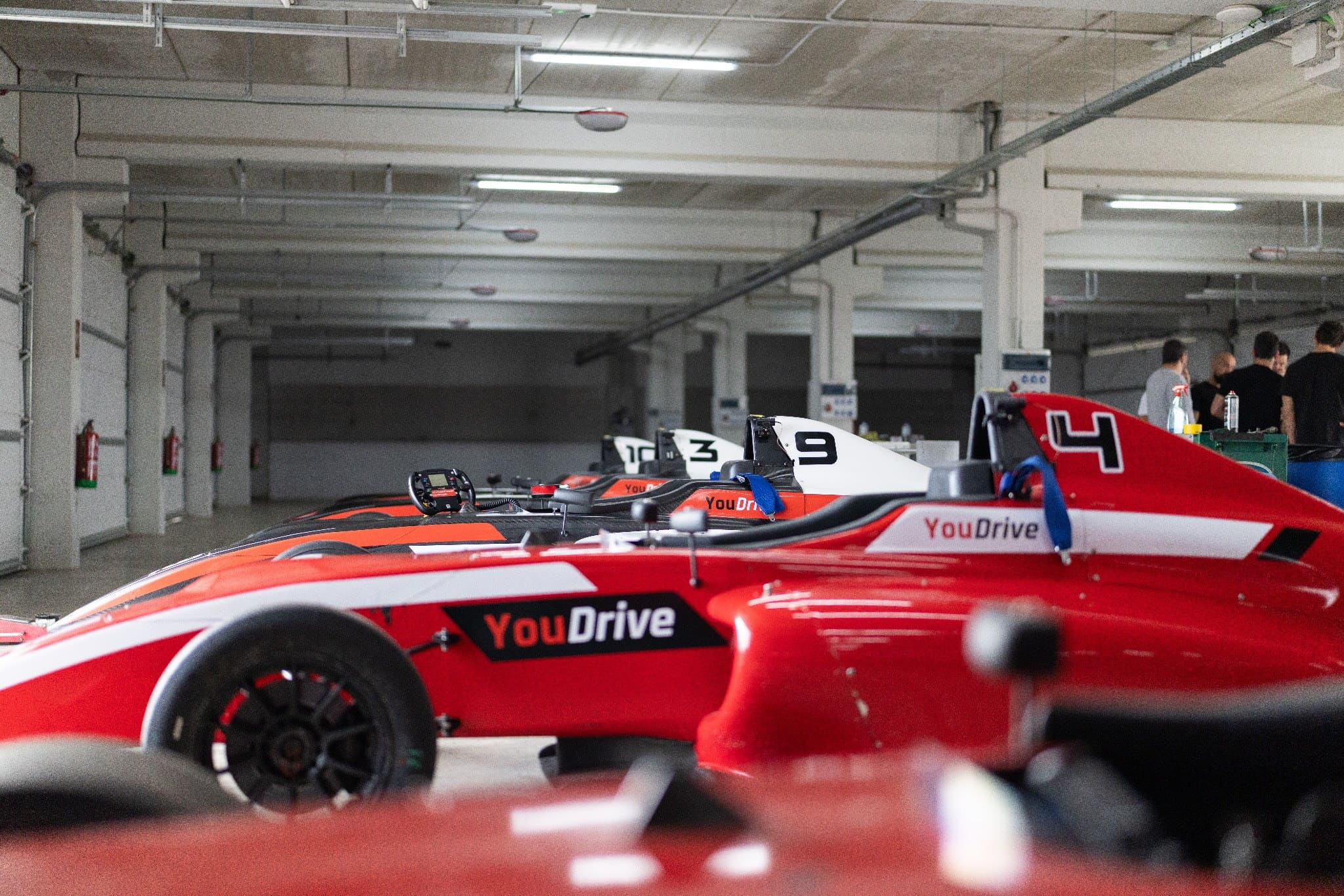 YouDrive F4 Formula 4 cars lined up in the garage before a premium driving experience